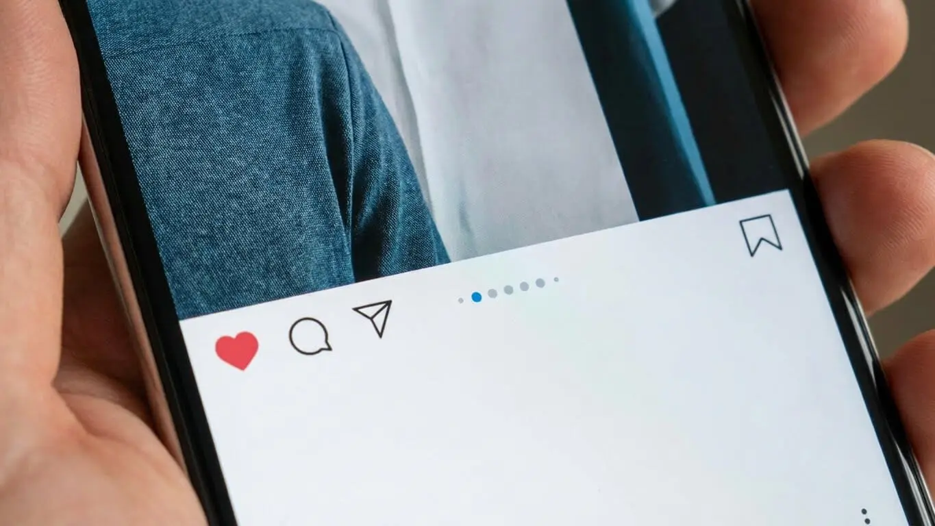 A close-up of a smartphone screen displaying an Instagram Carousel Post with no caption, highlighting the like, comment, and save icons—one of the best ways to enhance storytelling through interactive visuals. Uploaded on aifreeforever.com