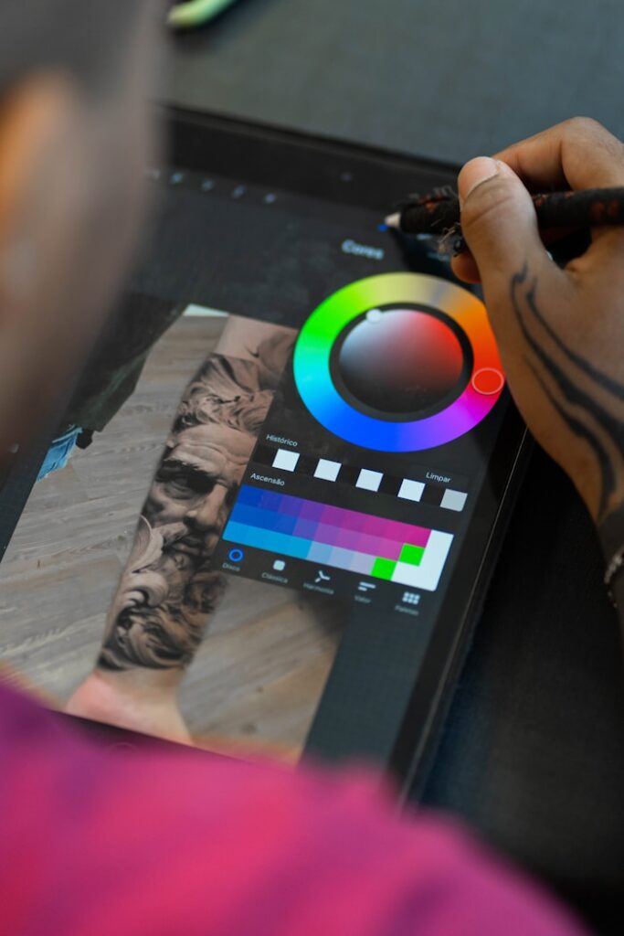 a person drawing on a tablet with a marker