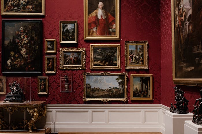 Discover classic art in an elegantly designed gallery space with red ornate walls.