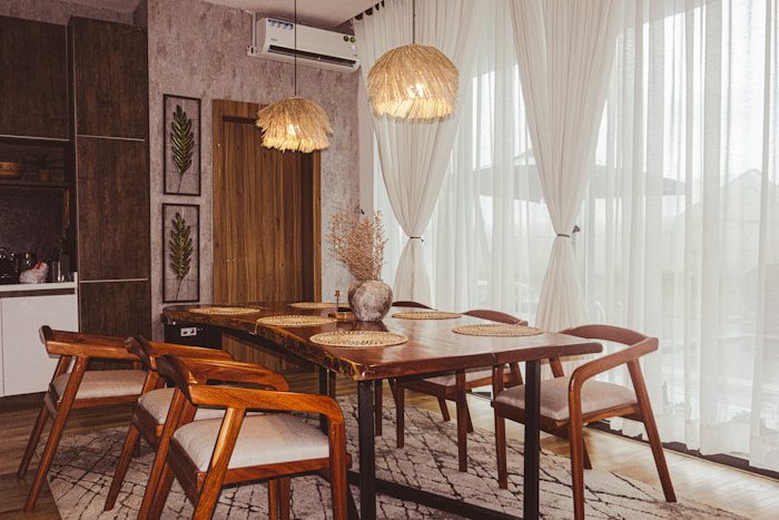 A dining room with a table and chairs