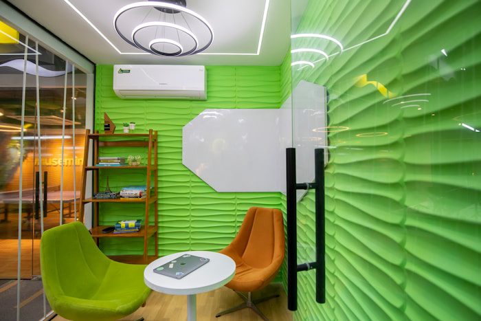 a room with a green wall and a white table
