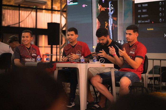 Four men sitting at a table during an event.