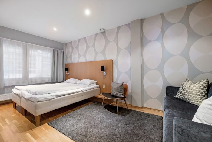 A bedroom with a bed and a couch in it